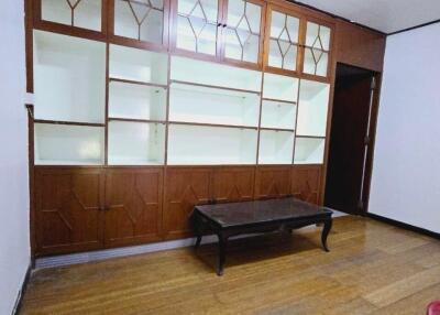 Living room with wood paneling and built-in shelves