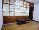 Living room with wood paneling and built-in shelves