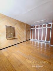 Spacious bedroom with wooden floors and built-in wardrobes