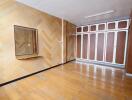 Spacious bedroom with wooden floors and built-in wardrobes