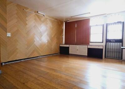 Spacious living room with wooden flooring and large windows