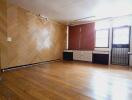 Spacious living room with wooden flooring and large windows