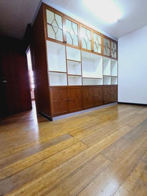 Spacious living room with built-in wooden shelving unit