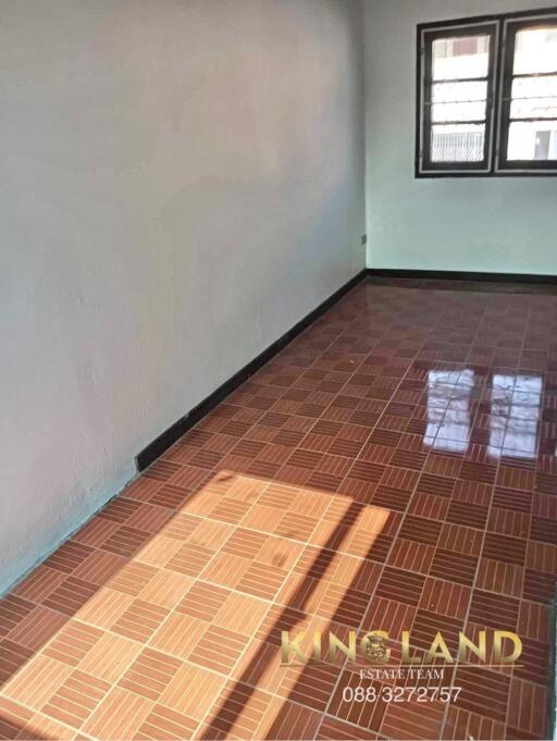 Empty bedroom with tiled floor and windows