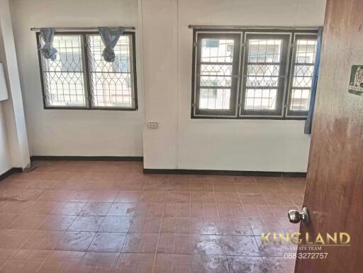 Bedroom with windows and metal grilles