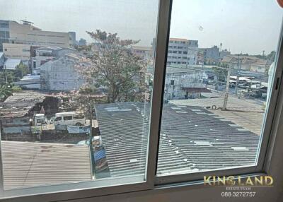 View from window overlooking buildings and trees