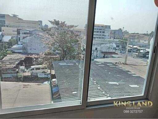 View from window overlooking buildings and trees