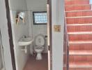 Small bathroom next to stairwell