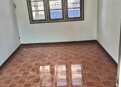 Empty bedroom with tiled floor and window