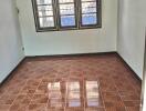 Empty bedroom with tiled floor and window