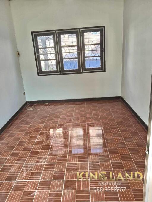 Empty bedroom with tiled floor and window