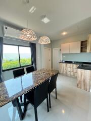 Modern kitchen with dining area and stylish lighting