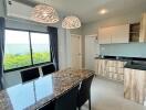 Modern kitchen with dining area and stylish lighting