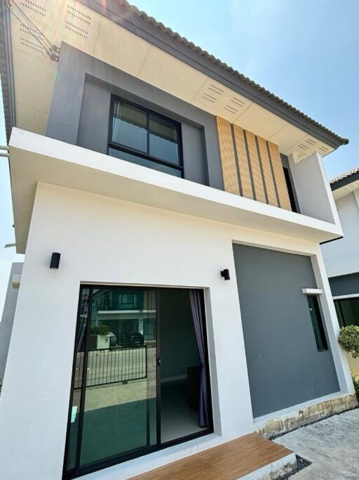 Front view of a modern two-story house with large windows