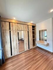 Bedroom with wooden floor and built-in wardrobe