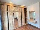 Bedroom with wooden floor and built-in wardrobe