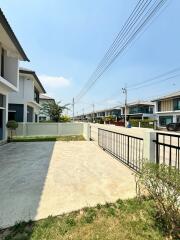 View of a residential neighborhood street with houses and a driveway