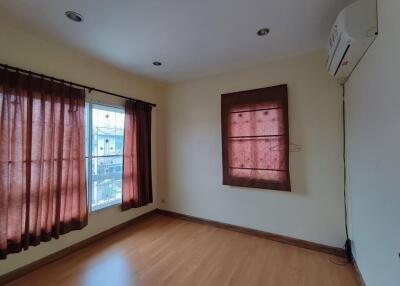 Bedroom with wooden floor and curtains