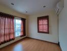 Bedroom with wooden floor and curtains