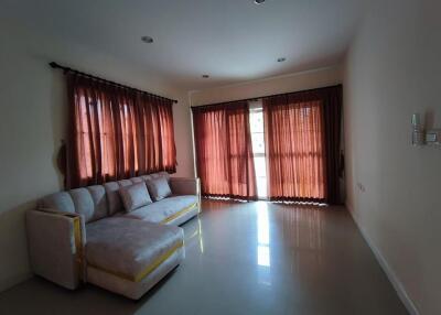 Living room with large windows and a sectional sofa