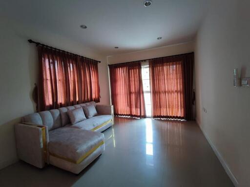 Living room with large windows and a sectional sofa