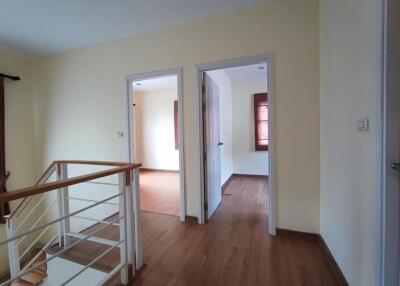 Hallway with wooden floor and doors leading to other rooms