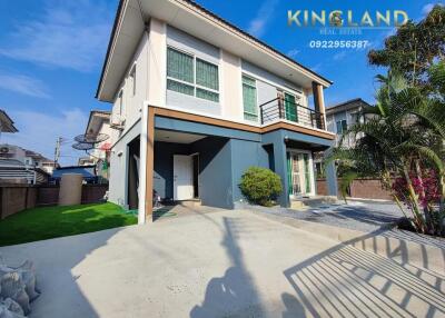 Modern two-story house exterior with a spacious front yard