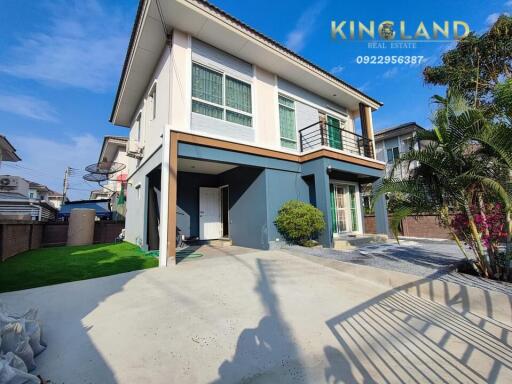 Modern two-story house exterior with a spacious front yard