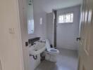 Modern bathroom with white fixtures and tiled flooring