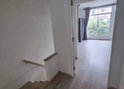 view from a staircase looking into a room with large window