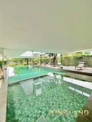 Indoor swimming pool with seating area and greenery view