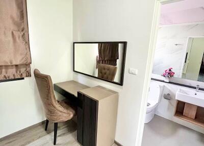 Bedroom with a dressing table and adjacent bathroom