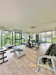 Modern gym with various exercise equipment and large windows