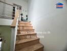 Staircase with wooden steps and white railings