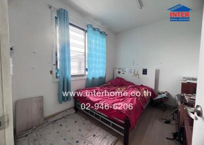 Single bed bedroom with window and simple furnishings