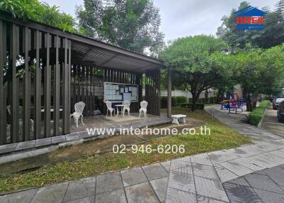 Covered outdoor seating area with bulletin board