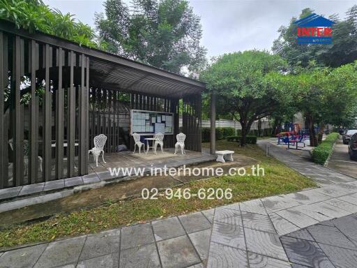 Covered outdoor seating area with bulletin board