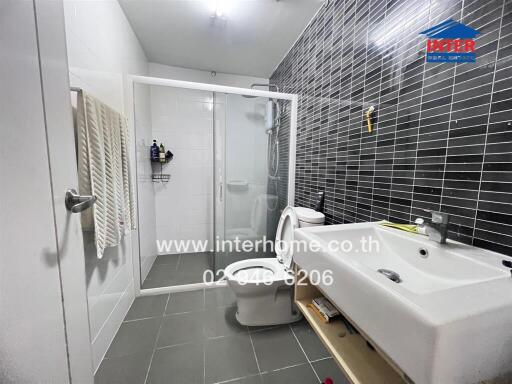 Modern bathroom with shower, sink, and toilet