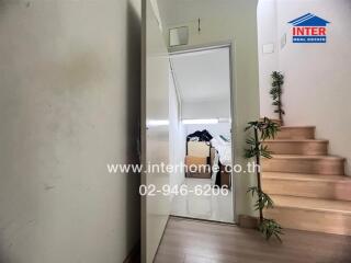 Entrance hall leading to bedroom and staircase