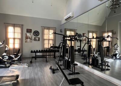 Home gym with workout equipment and mirrors