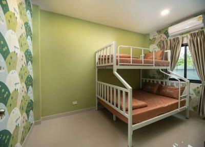 Bedroom with bunk beds and green wall