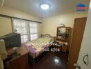 Bedroom with bed, wooden furniture, and window