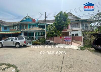 Exterior view of residential houses with vehicles parked outside