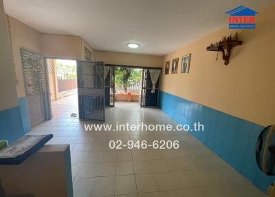 Spacious living room with tiled floors and natural light