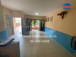 Spacious living room with tiled floors and natural light