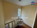 Staircase with beige walls and white railing