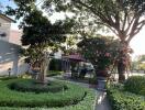 Manicured garden with statue, trees and outdoor seating area