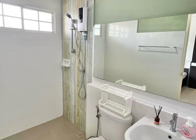 Modern bathroom with shower, toilet, and sink