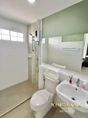 Modern bathroom with shower, toilet, and sink