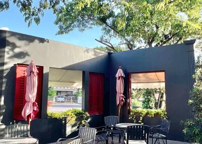 Outdoor patio area with seating and greenery